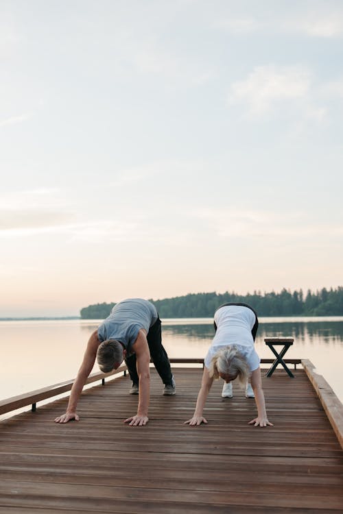 Photo of an Elderly Woman and an Elderly Man Exercising