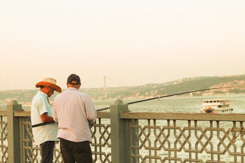 Backview of Elderly Men holding a Fishing Rod 