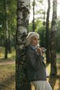 Woman in Black Coat Standing Beside Tree