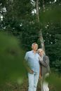 Man in White Button Up Shirt Standing Beside Woman in Gray Dress