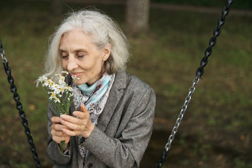 Woman Smelling White Flowers