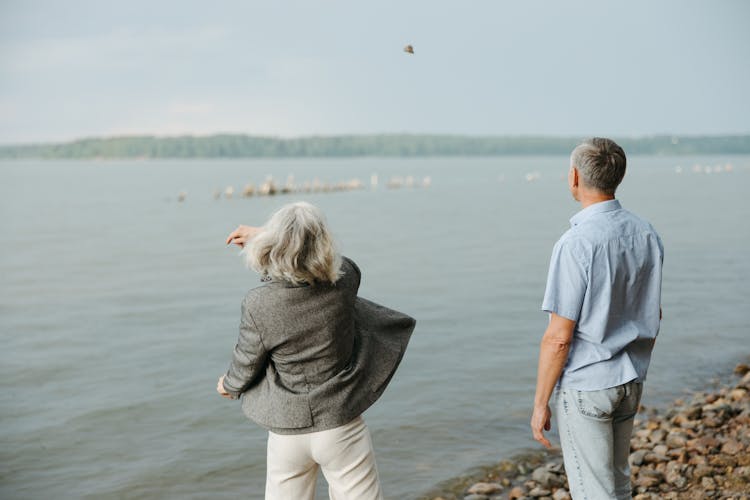 Back View Of A Woman Throwing A Rock