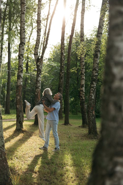 An Elderly Couple Dancing Near Trees