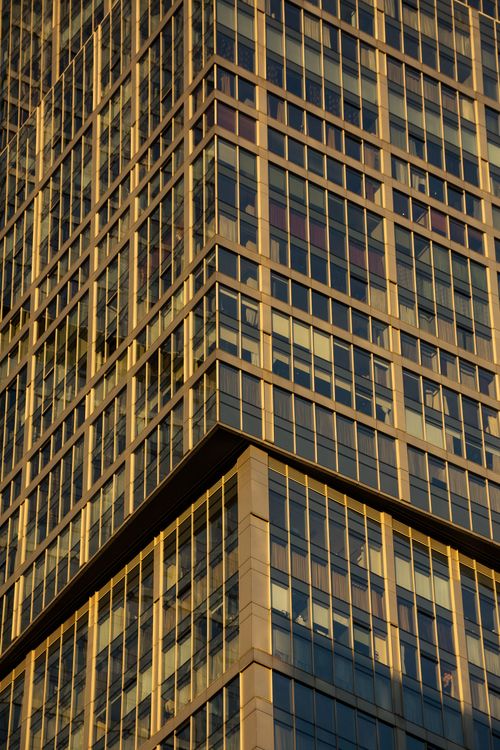 Free A detailed view of a glass-clad skyscraper facade capturing modern architectural design. Stock Photo