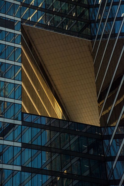 Free Close-up view of a modern skyscraper facade reflecting the evening light. Stock Photo