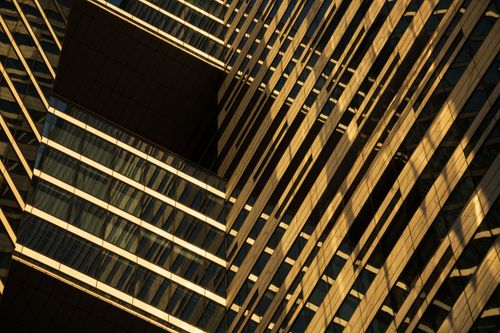 Free Close-up view of a modern building with glass and geometric design. Stock Photo