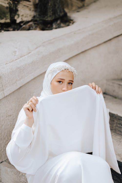 Free Woman in White Hijab Holding White Textile Stock Photo