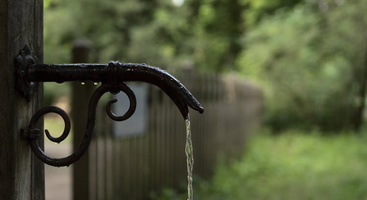 Black Metal Spout With Dripping Water