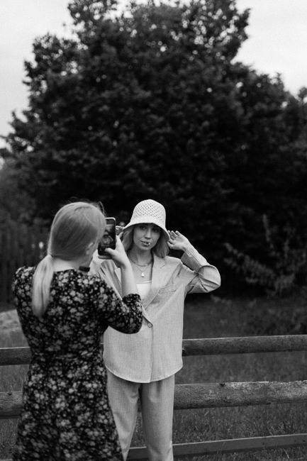 Two women in a black and white outdoor portrait scene.