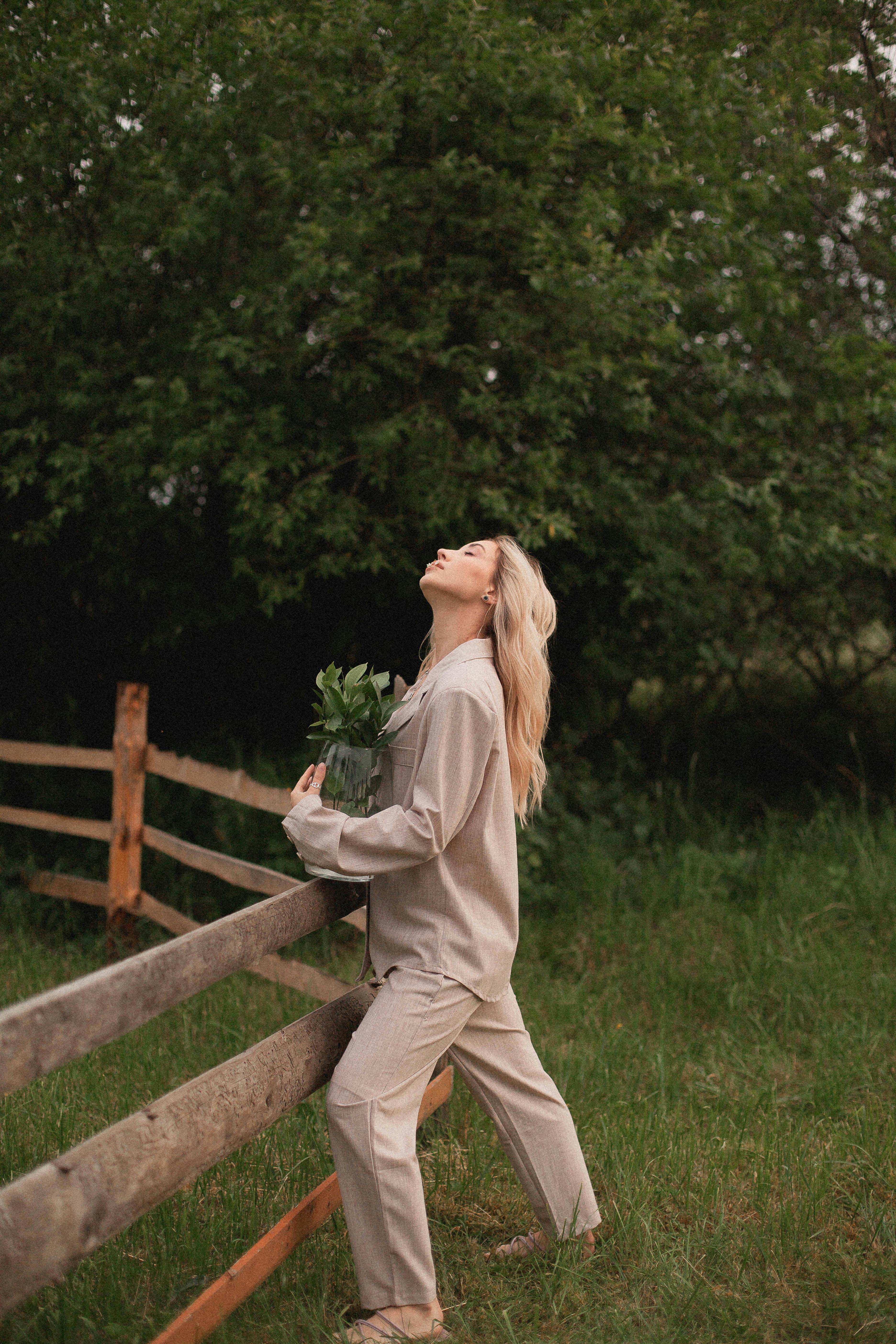 woman leaning on the wooden fence