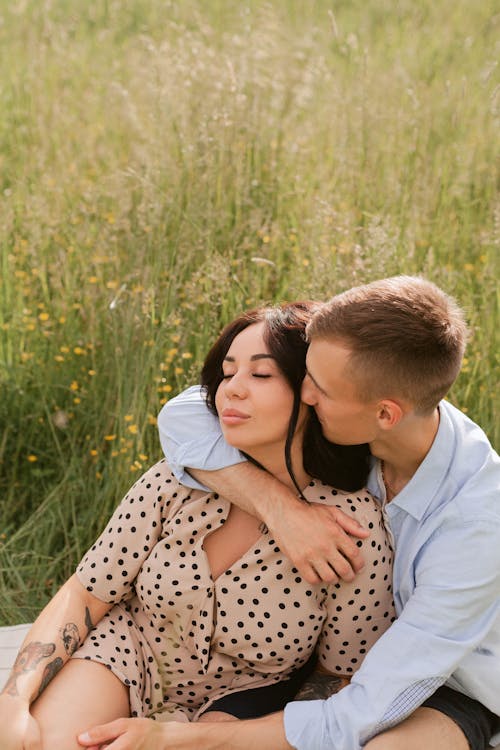 Free A Man Hugging a Woman while Her Eyes are Closed Stock Photo