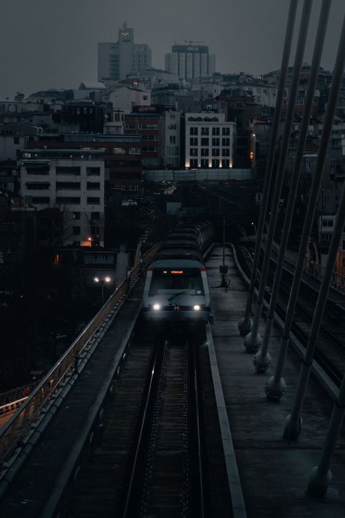 Free A train moves over the Golden Horn Metro Bridge in Istanbul during a dark evening, showcasing city life and transportation. Stock Photo