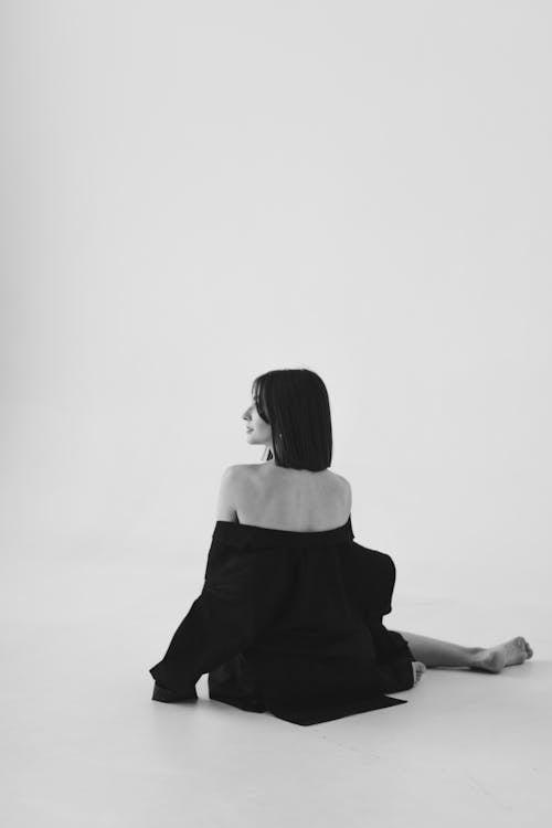 Free Woman in Long Sleeves Sitting on the Floor Stock Photo