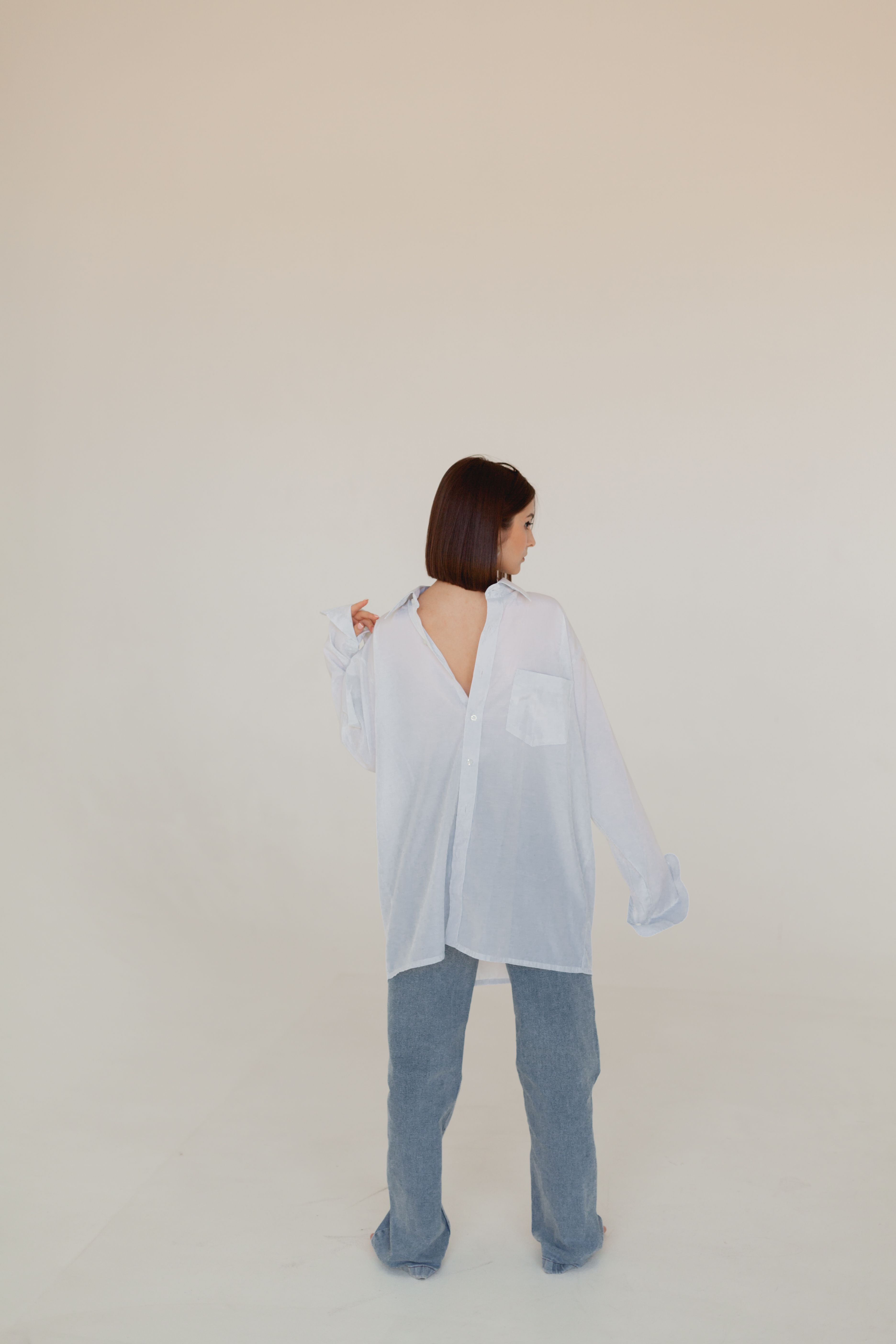 Woman in White Long Sleeve Shirt and Blue Denim Jeans · Free Stock Photo