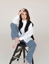 Beautiful Woman in White Dress Shirt and a Black Vest and Denim Pants