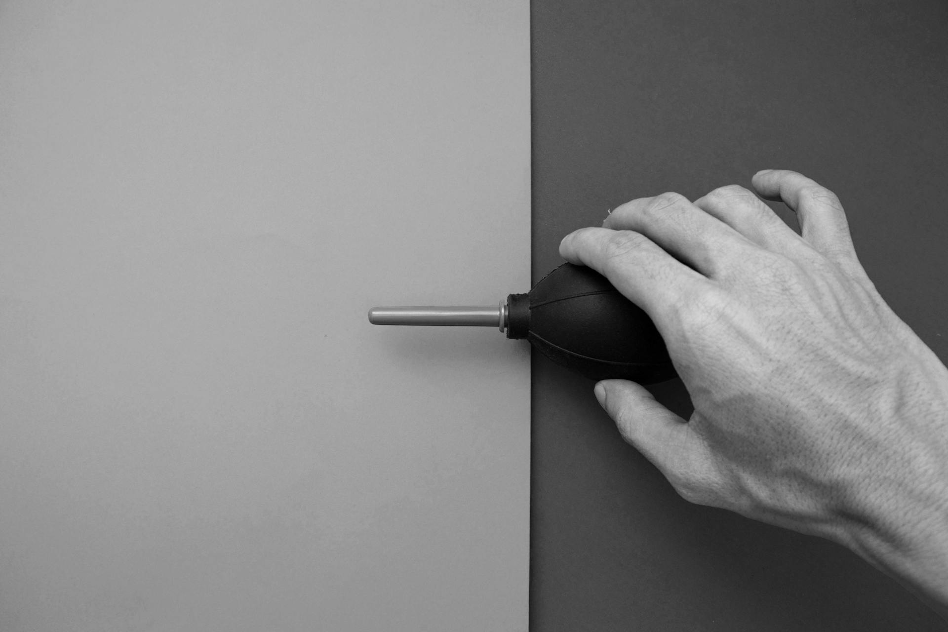 A Person Holding a Rubber Hand Air Pump Blower