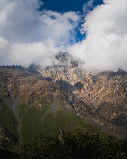 Free Breathtaking view of rugged mountains topped with clouds, rich in natural beauty. Stock Photo