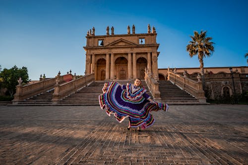 Free Woman Dancing in a Striped Pollera Dress in the Square of the Templo del Calvario Stock Photo