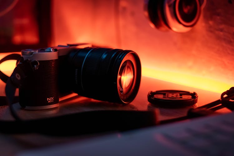 Black Camera With Long Lens On Table