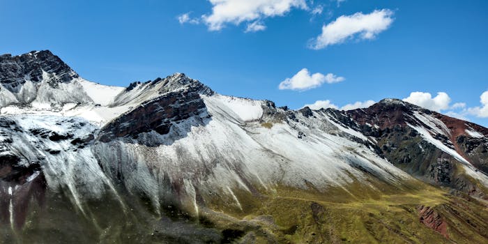 Breathtaking view of snow-covered Rainbow Mountain in Cusco, Peru under a clear blue sky.