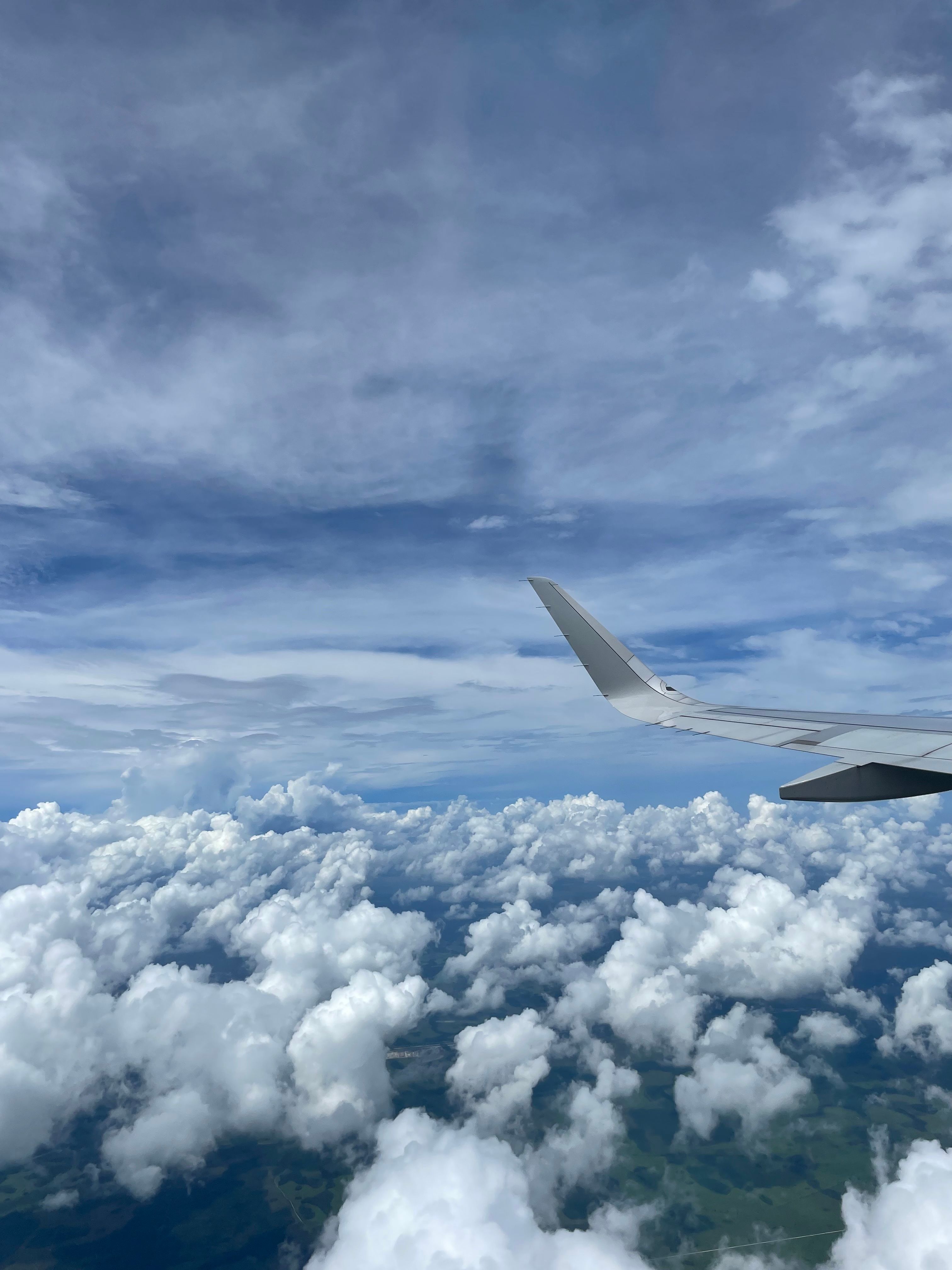 Airplane Wing over Fluffy White Clouds · Free Stock Photo