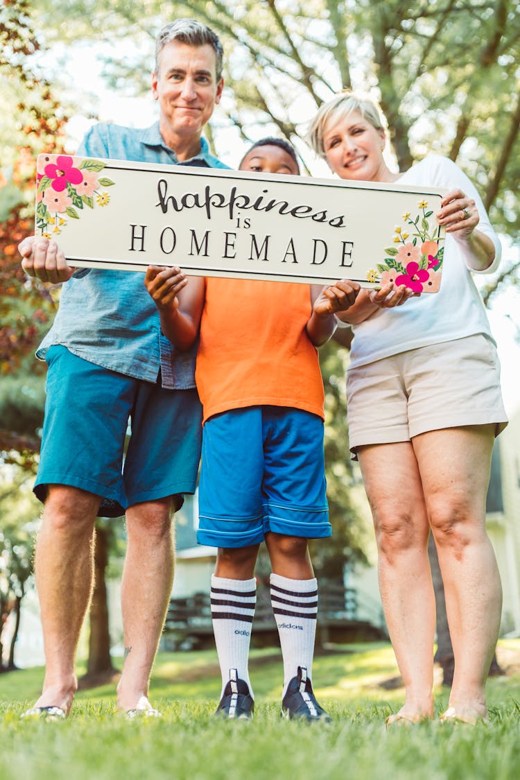 A Family Holding Text Sign Board