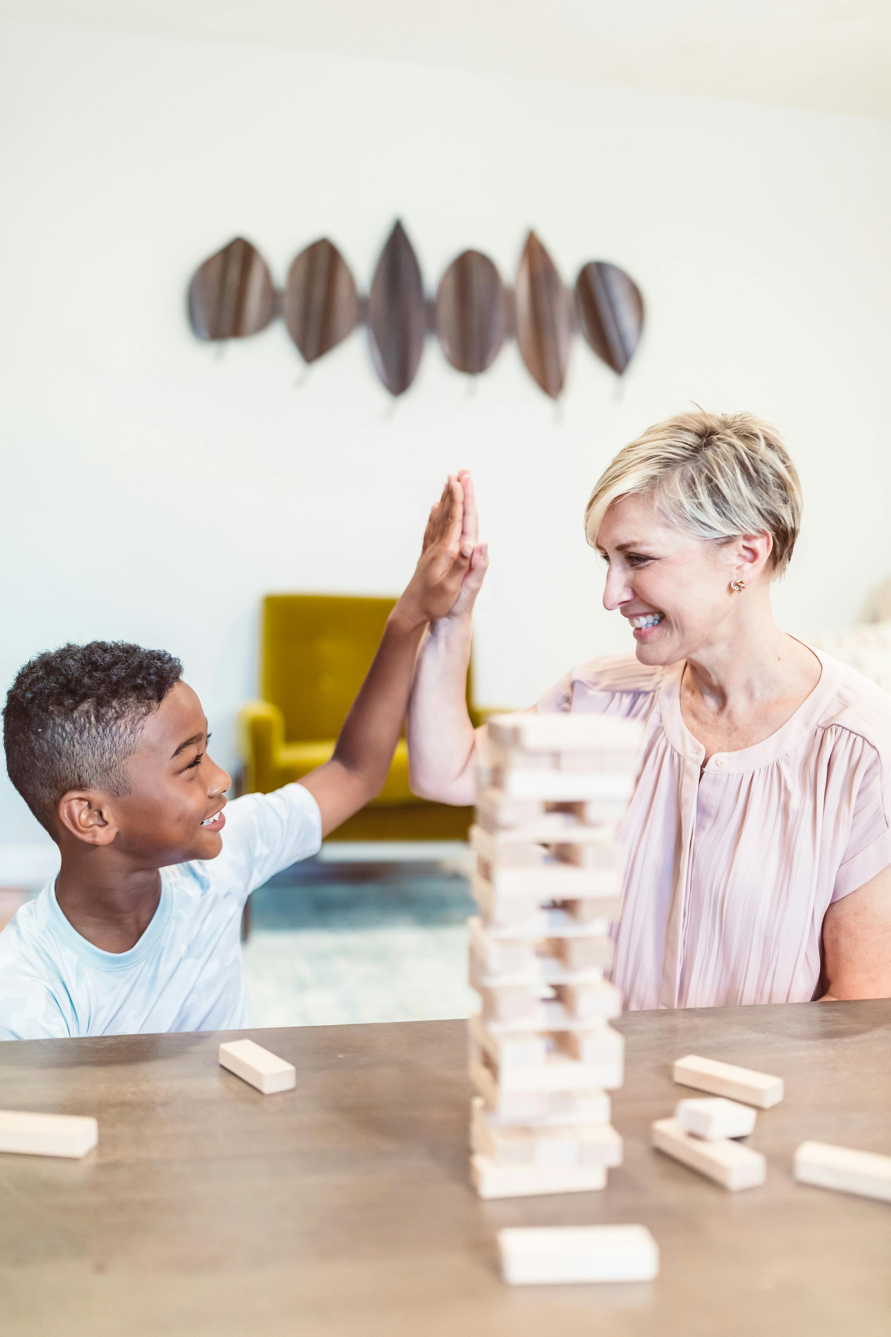 Mom and Son Having Fun Playing Jenga · Free Stock Photo