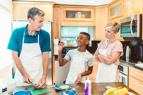 Free Happy Family Preparing Food in the Kitchen Stock Photo