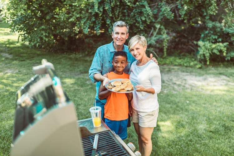 Family Picnic With Hamburgers From Grill