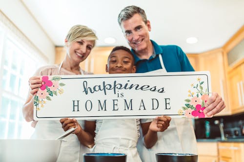 Free Happy Family Holding a Banner Stock Photo