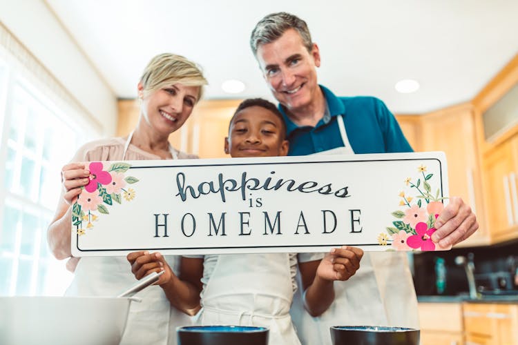 Happy Family Holding A Banner