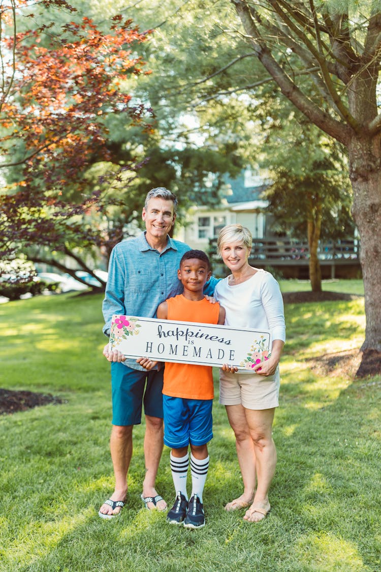 Happy Family Holding A Banner