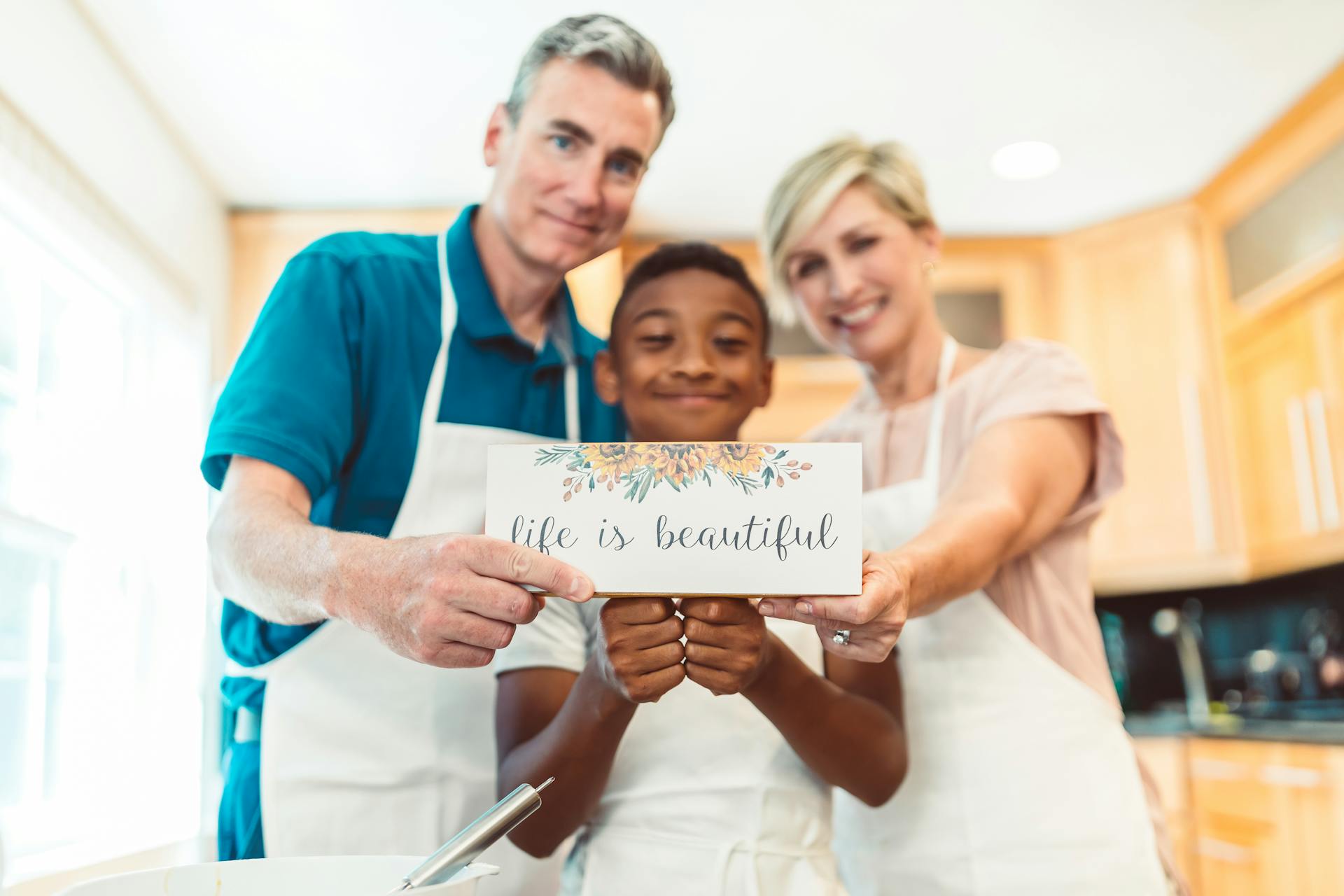 A Family Holding a Card with Message