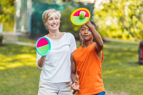Free Mother and Son playing Velcro Ball Game  Stock Photo