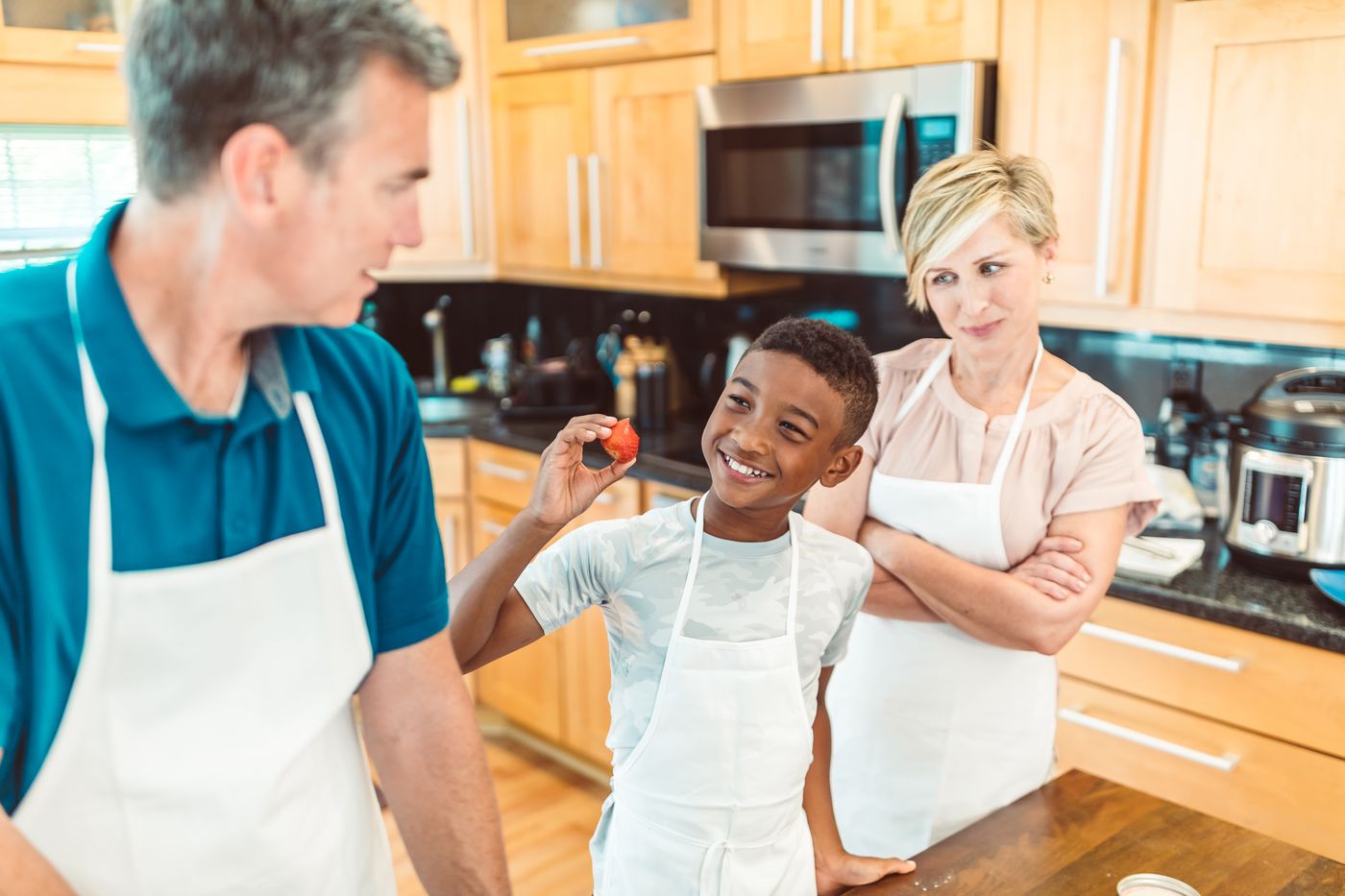 Happy family laughing together in beautifully renovated kitchen