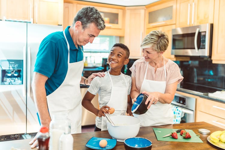 A Family Baking At The Kitchen 