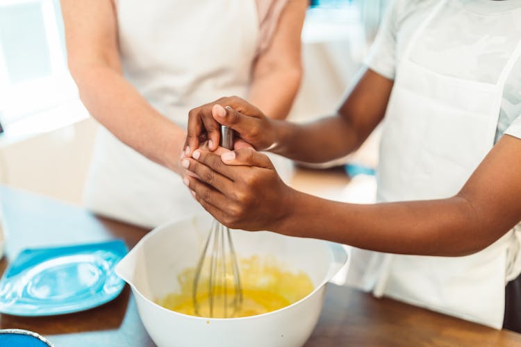 Person Stirring On White Mixing Bowl 