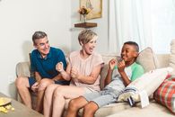 A Family Sitting on a Beige Couch