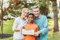 A  Family Holding A Sign With Quote