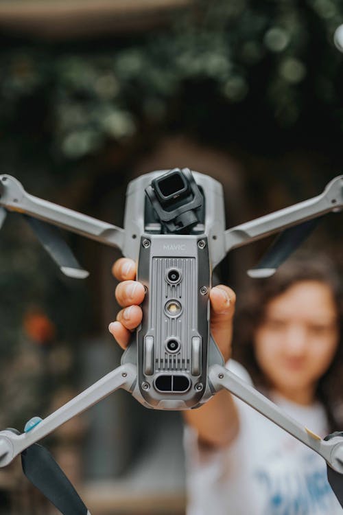 Hands of a Person Holding a Drone