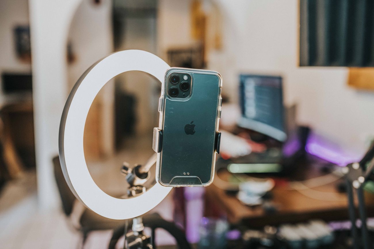 Smartphone positioned inside a ring light for recording creator content
