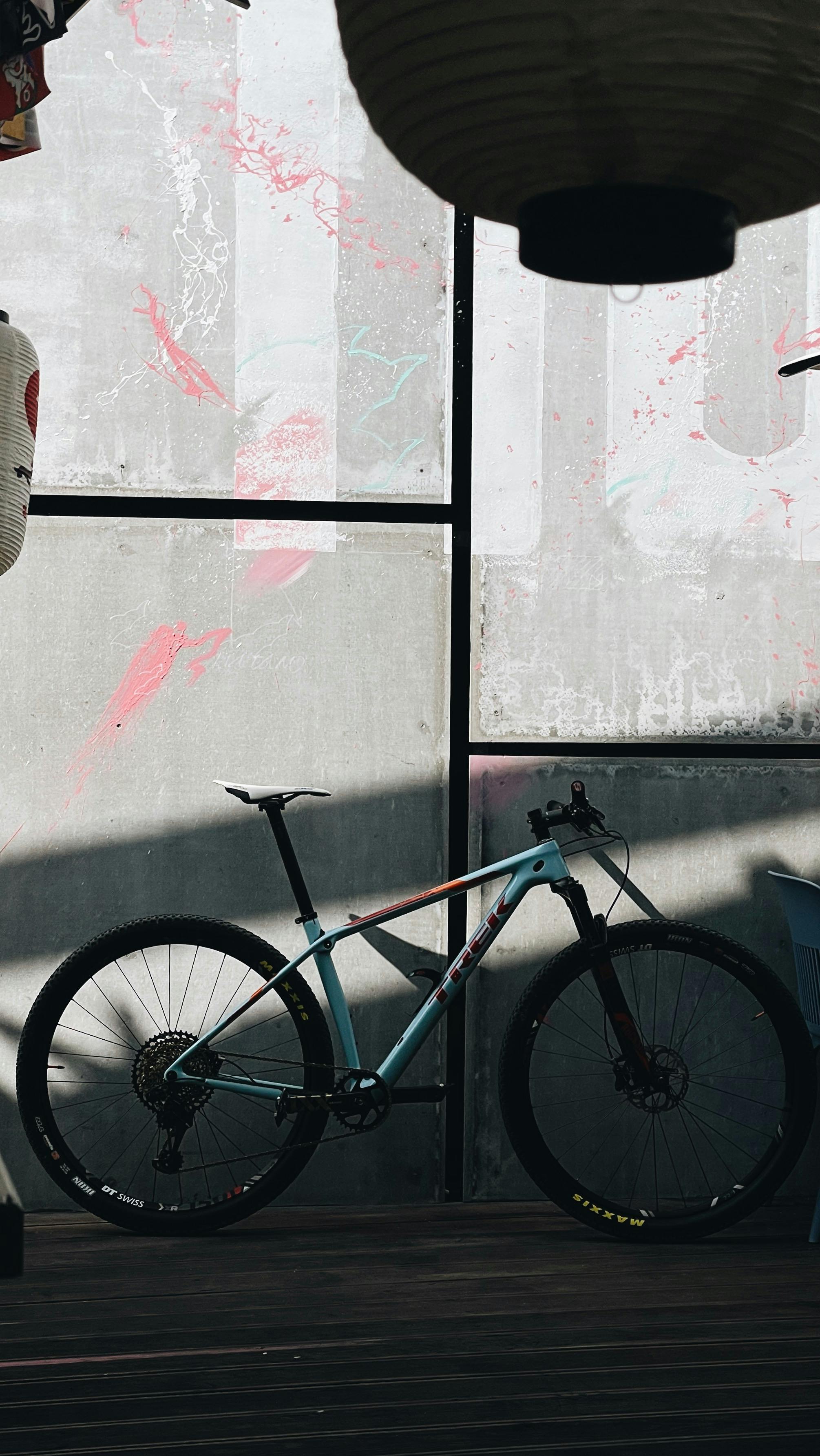 mountain bike leaning on gray wall