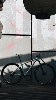 A modern mountain bike resting against a graffiti-covered wall in an urban setting, perfect for adventure themes.