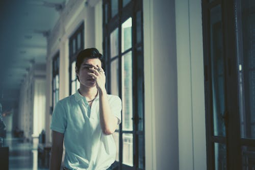 A Man Covering his Face with his Hand