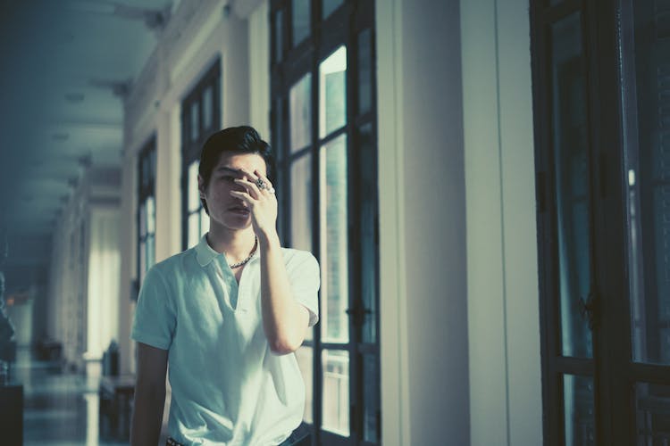 A Man Covering His Face With His Hand