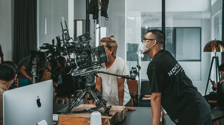 A film crew collaborating in a modern studio, photo by Minh Tri on Pexels