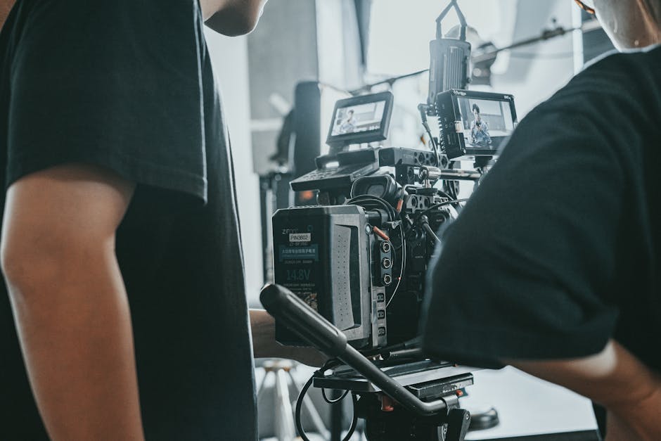 Film crew operating professional camera equipment