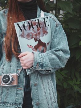 Woman in Blue Denim Jacket Holding White and Red Heart Drawing