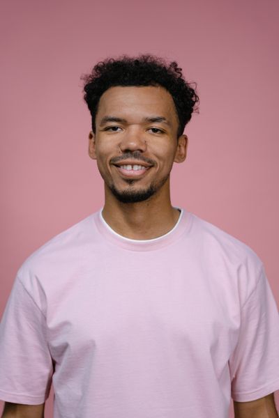 James T., cheerful man in a pink shirt