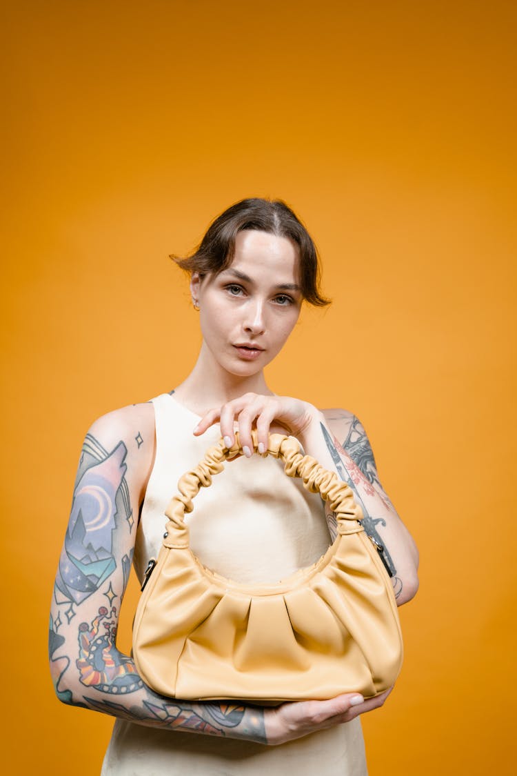 Stylish Woman Holding A Leather Handbag 